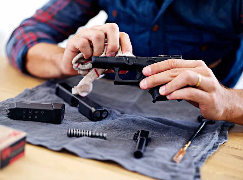 Man cleaning his pistol