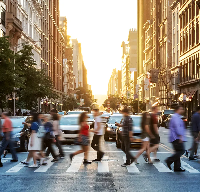 People walking through crosswalk in city