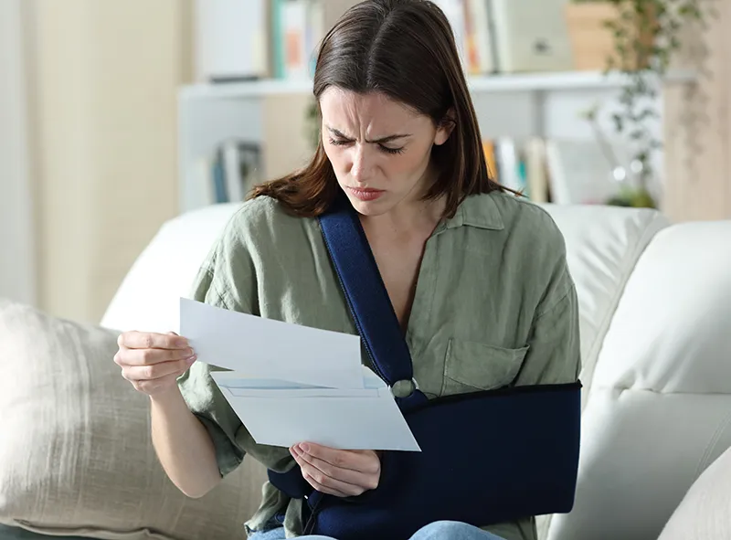 Woman reading surprise bill she just got in the mail