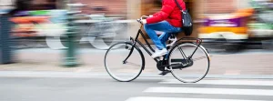 Man biking to work in the city